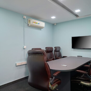 Modern private office workspace in MG Road, Kochi with desks and meeting area.