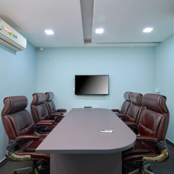 Modern private office workspace in MG Road, Kochi with desks and meeting area.
